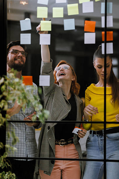 istock Team brainstorm session with colorful sticky notes at a creative workspace, showcasing collaboration and idea generation during a bright afternoon 2240272607