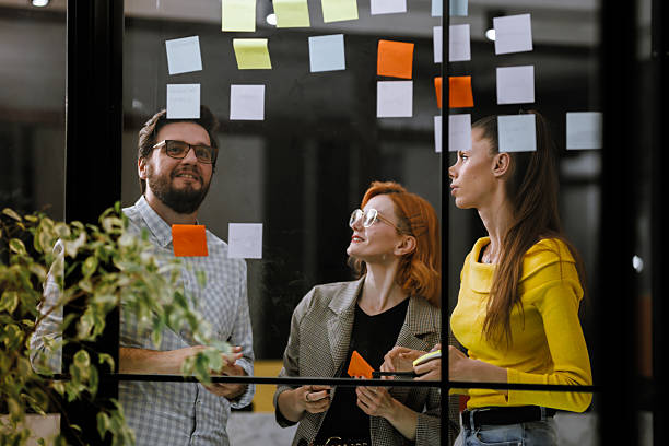 istock Team members collaborating on project planning with colorful sticky notes in an office setting during the afternoon 2240272626