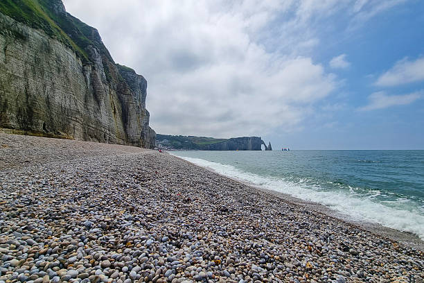 istock Coastal Cliffside Pebble Beach by the Ocean Under a Blue Sky 2240277344