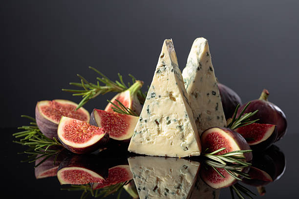 istock Blue cheese with fresh figs and rosemary on a black background. 2240277628