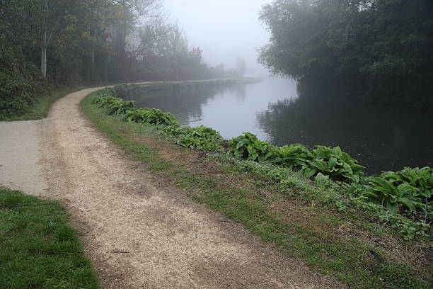 Autumn early morning fog public river Wey footpath Guildford Surrey England