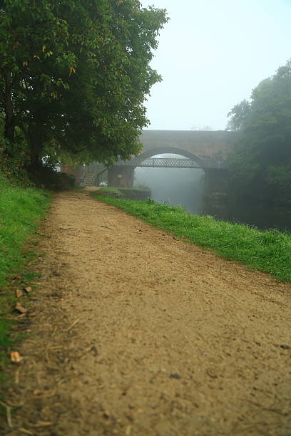 Autumn early morning fog public river Wey footpath Guildford Surrey England