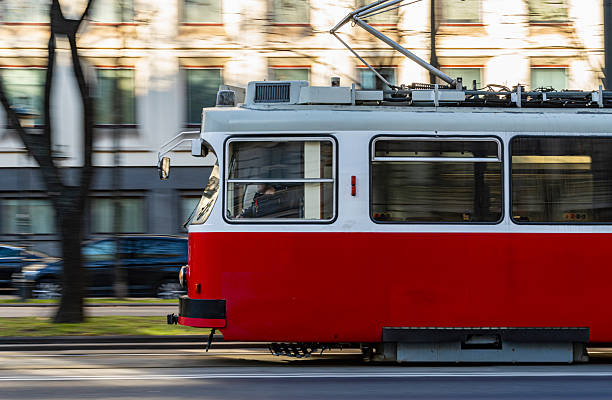 istock Classic Red Tram in Motion on City Street 2240281470