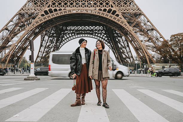 istock Two Friends Enjoying Their Trip to Paris with the Eiffel Tower in the Background 2240283349