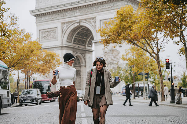 istock Two Friends Walking in Front of the Arc de Triomphe in Paris 2240283400