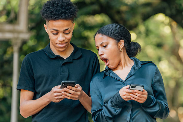 istock couple spying on cell phone 2240285604