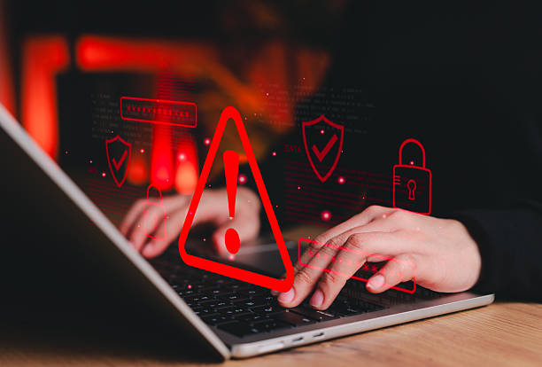 istock Cybersecurity alert concept. Person using laptop showing red warning symbol representing data breach, system hacking notification, cyber risk and online security threat detection in digital networks. 2240286508
