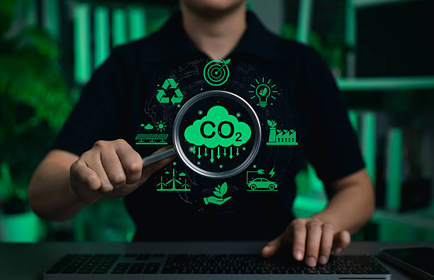 istock Carbon footprint and CO2 emission reduction concept. Person analyzing green sustainability icons, symbolizing environmental conservation, recycling, renewable energy and climate change awareness. 2240286521