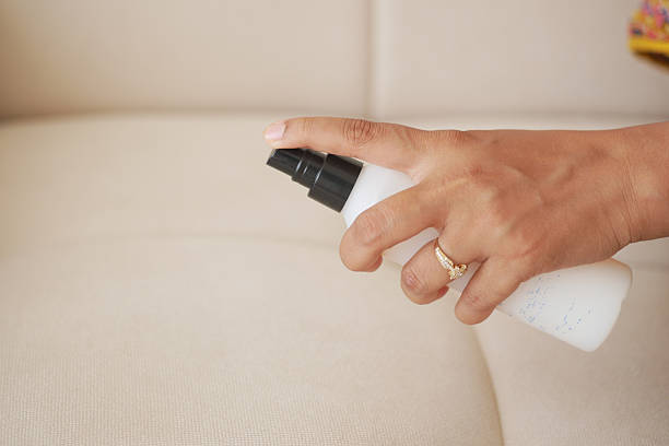 istock Hand with cleaning spray bottle indoors 2240286624