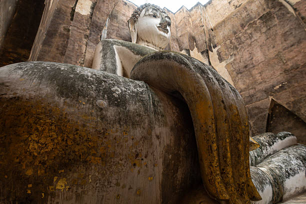 istock Buddha image Phra Atchana in subduing mara posture at Wat Sri Chum temple 2240287838