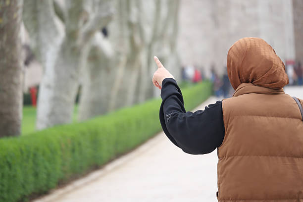 istock Person pointing at park trees 2240287892