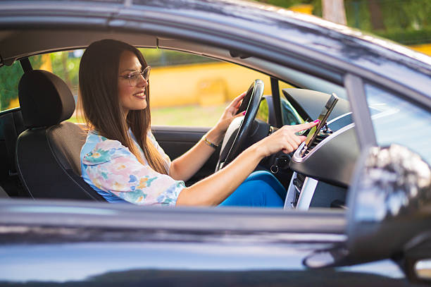 istock Young smiling woman driving her modern car 2240288532