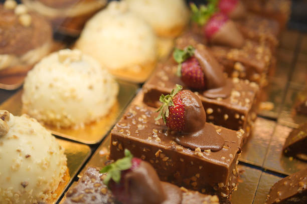 Exquisite desserts displayed with fresh strawberries and chocolate icing.