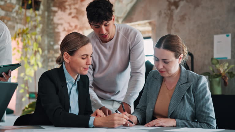 Business, documents and women in meeting, recruitment and conversation with signature. Contract, human resource management and people in office, cooperation and agreement for nda policy and paperwork