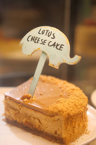A slice of lotus cheesecake sits on a plate with a cute sign.