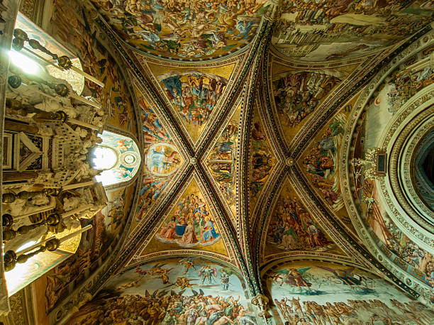 Inside Orvieto's Duomo, chapel ceilings dazzle with vivid frescoes. Sacred scenes unfold across vaulted ribs, blending Gothic architecture with Renaissance artistry in a deeply spiritual setting.