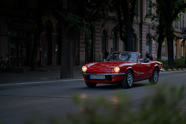 Triumph TR2 red roadster sports car parked in Spain.