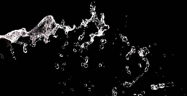 istock Water drops falling on black background. Splashing in motion. Water texture design. Splash with bubbles. Dripping water overlay pattern. Water splash. Falling drops. 2240297638
