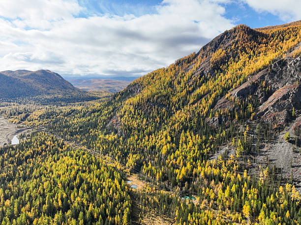 istock Forested valley with geyser lakes and steep autumn mountains 2240297811