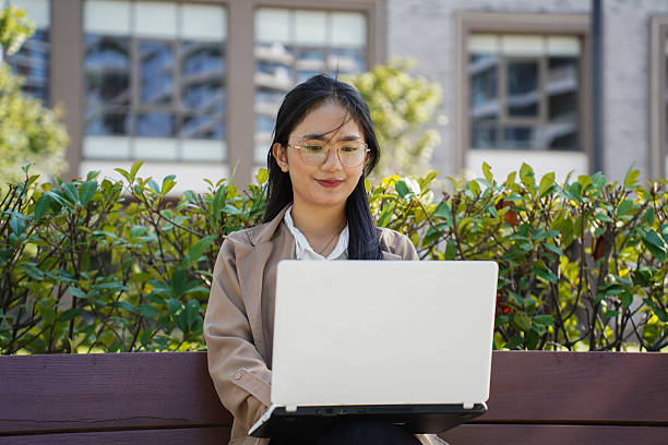 istock Freelance woman enjoying remote work outdoors 2240302957