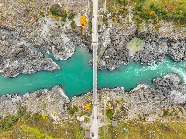 istock Top-down view of a narrow bridge spanning a turquoise river gorge 2240303754