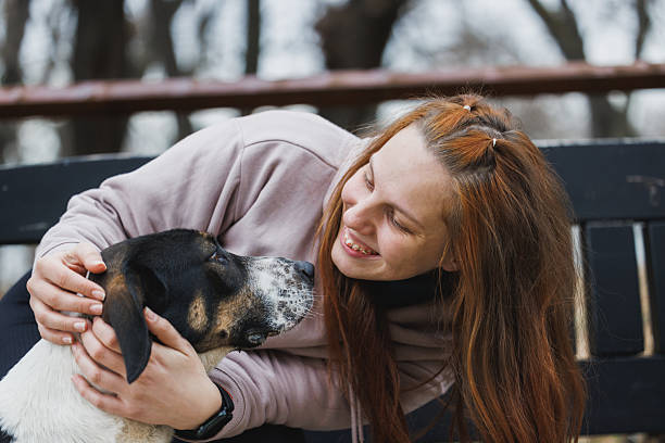 istock Woman With a Dog in a Park 2240304249