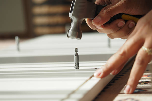 istock Hammering nails into wood for home improvement project 2240305344