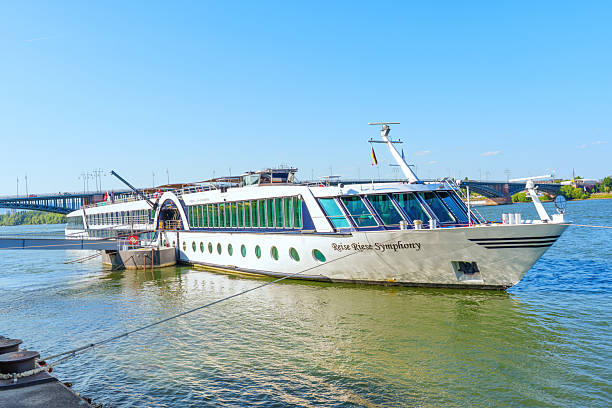 Mainz, Germany - June 19, 2025: Cruise ship named 'Reise Reise' docked on the Rhine River in Mainz, Germany, reflecting clear blue skies and vibrant waters.