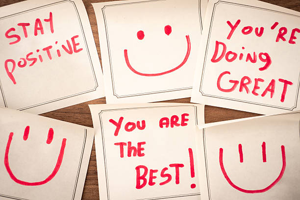Sticky notes with a positive message, on a wooden background. Creative background.