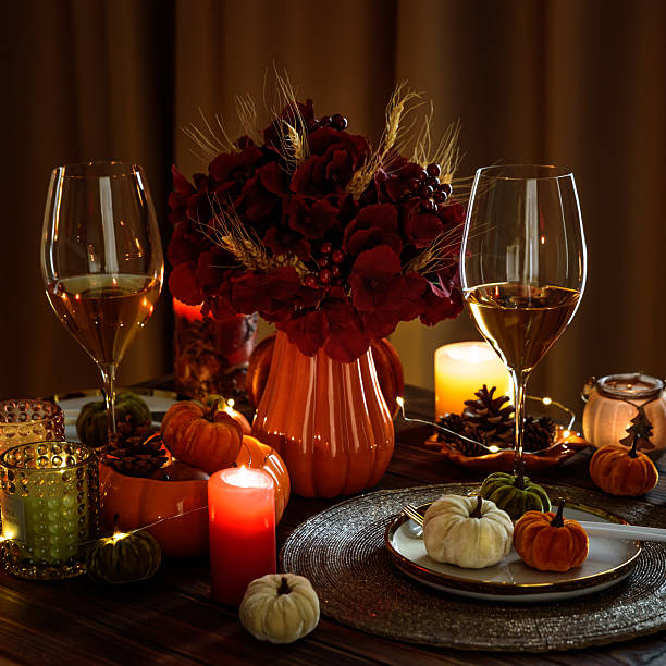 istock Thanksgiving table setting with decorative pumpkins, candles and string lights on dark wooden table 2240309889