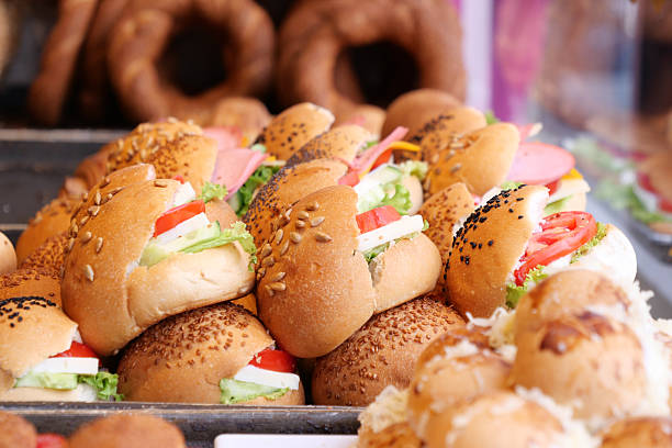 Colorful sandwiches filled with vegetables on display at a market stall.