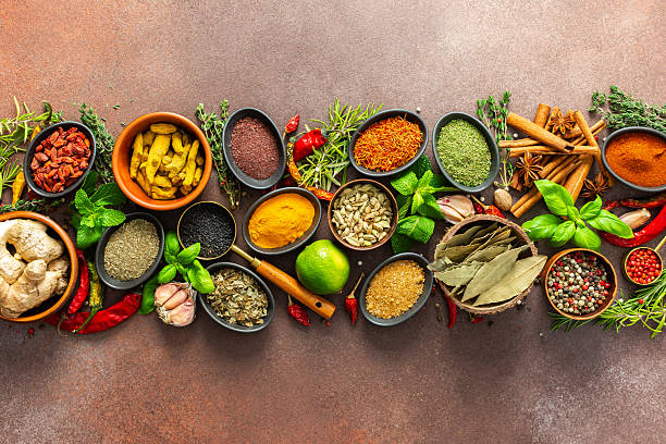 istock A stunning spread of fresh spices and herbs, meticulously arranged on a deep brown backdrop, capturing their vibrant colors and tantalizing aromas 2240312789