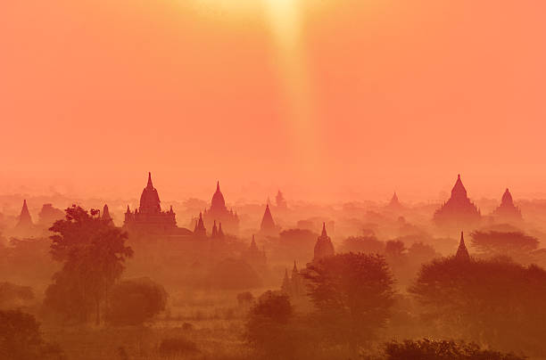istock Silhouettes of temples with orange sky background. 2240314676