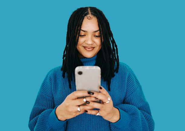 istock Joyful Black Woman Using Smartphone On Blue Background Digital Joy Concept 2240316567