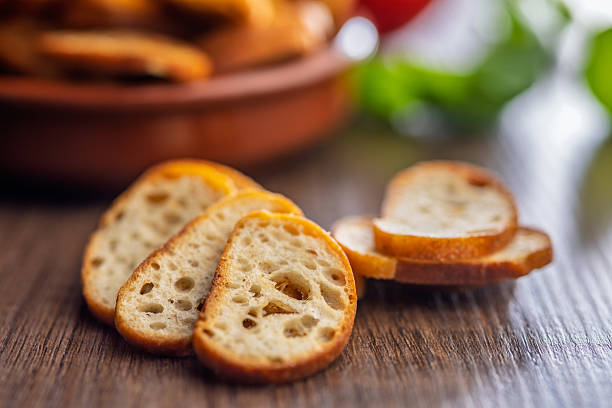 istock Crispy roasted bruschetta bread on wooden table. 2240317617