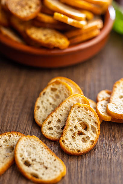 istock Crispy roasted bruschetta bread on wooden table. 2240318980