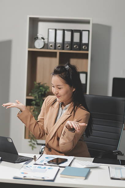 istock Asian Businesswoman Using laptop computer and working at office with calculator document on desk, doing planning analyzing the financial report, business plan investment, finance analysis concept. 2240319320