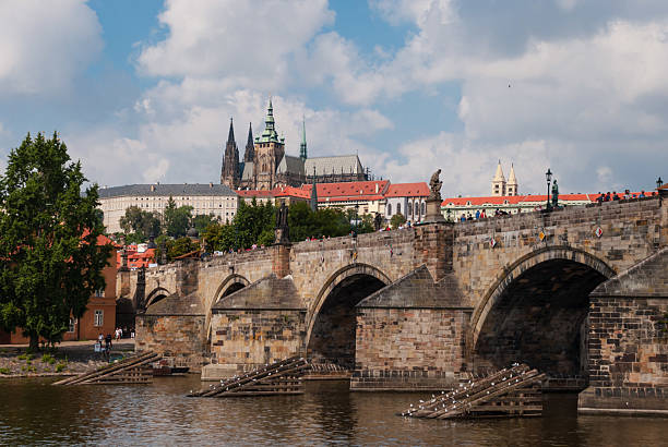 Prague, Czech - August 22, 2013 - Historic charles bridge over vltava river with prague castle in background.