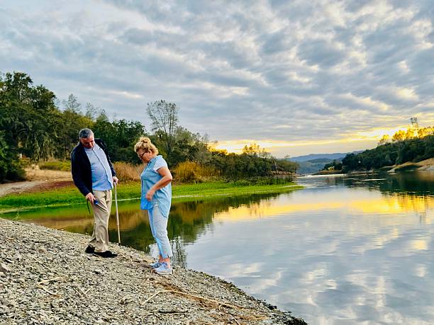A couple is enjoying their time in nature. They are enjoying the sunset at the Lake Hennessey, California. During September 2025.