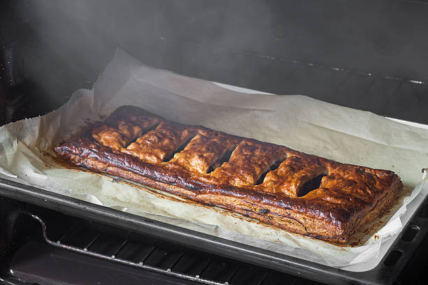 Puff pastry tart with burnt apple, a concept of carelessness and kitchen safety.