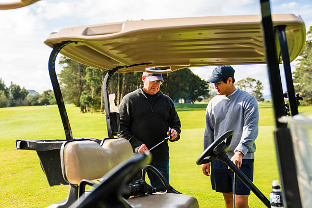 istock Standing by thecart two golfers sharing a light conversation. 2240326099