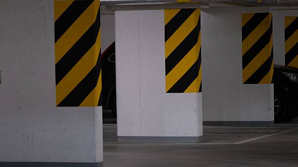 istock Underground parking pillars with yellow black warning stripes 2240327000