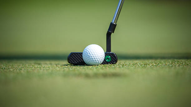 istock Close-Up Of Golf Ball On Putt-Frame With Putter On Green Grass, Sharp Focus On Tee Line 2240330054