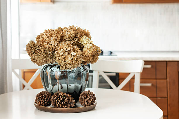istock Cozy kitchen table with autumn hydrangea flowers at home Interior. 2240332036