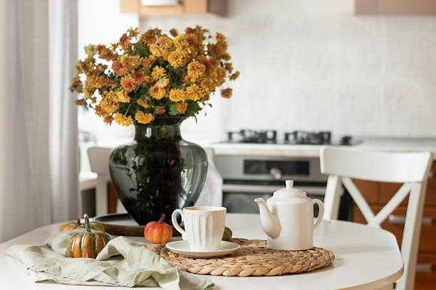 istock Cozy Kitchen Table with Autumn Flowers at Home Interior. 2240332037