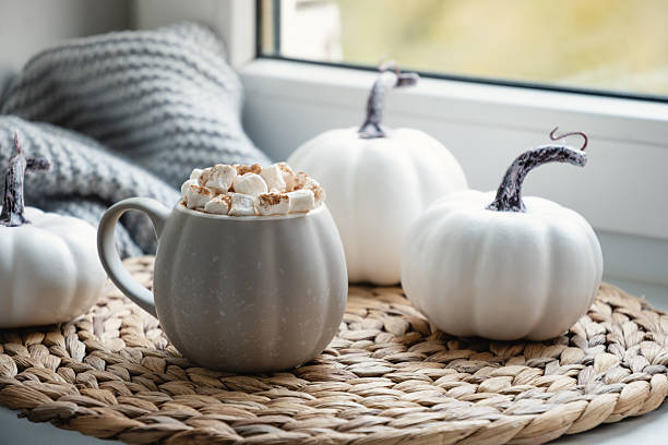 istock Autumn warming chocolate or coffee on windowsill. Autumn beverage 2240332039