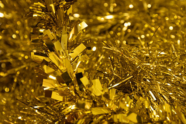 Festive golden color  tinsel as background  . Celebration backdrop, party decorations .
