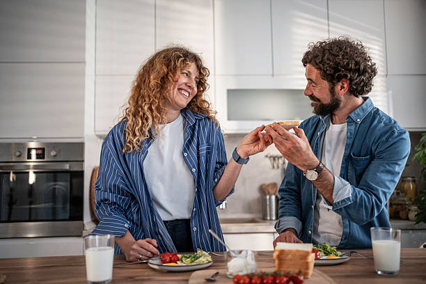istock Happy couple sharing breakfast in modern kitchen 2240335406