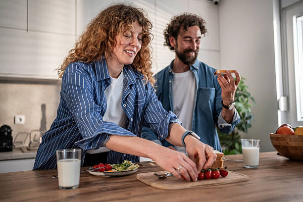 istock Happy couple preparing healthy breakfast in kitchen 2240335409