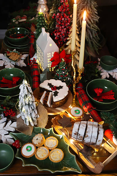 Image of festive christmas dinner dining table with candles, trees, and elegant decorations / holiday food, place settings